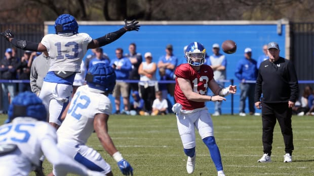 Kentucky s Devin Leary throws the ball past J.J. Weaver (#13) during open practice for the fans on Saturday.April 1, 2023 Kentuckypractice 03